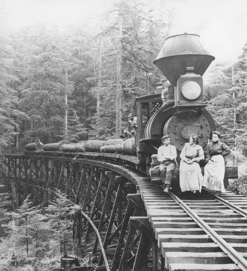 Logging train crossing a trestle bridge in the Cascade Mountains, Oregon.