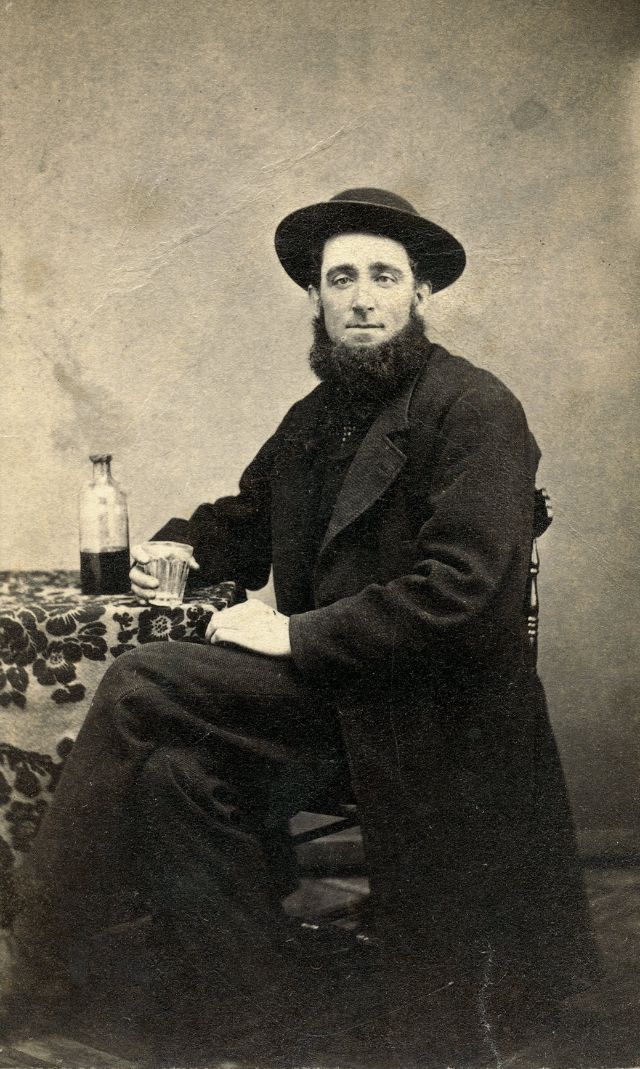 Man posing for a glass of whiskey