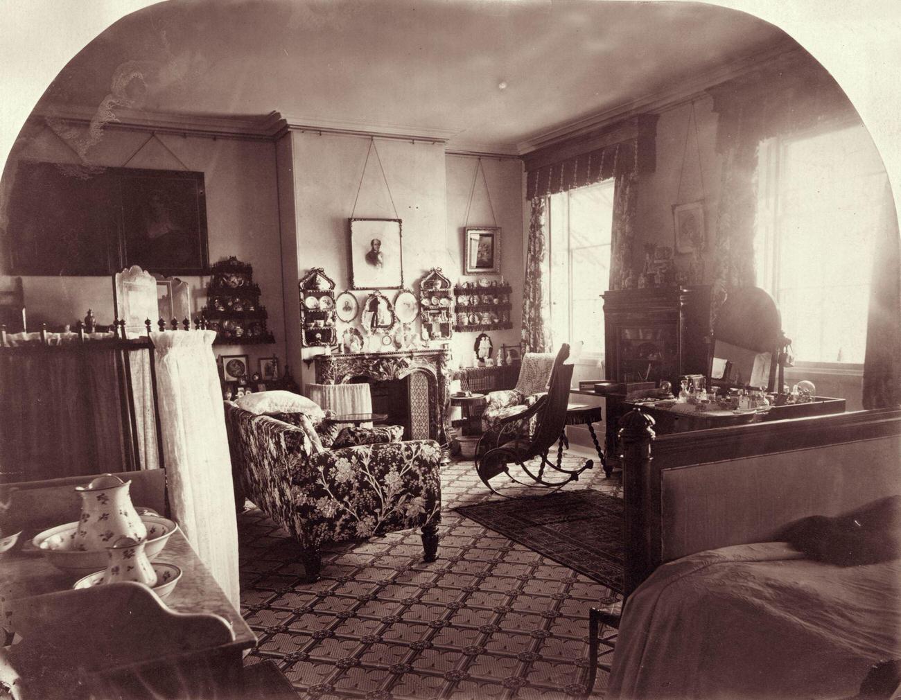 Interior of a living room in Norris Green, 1860, featuring a chintz sofa and shelves of china.