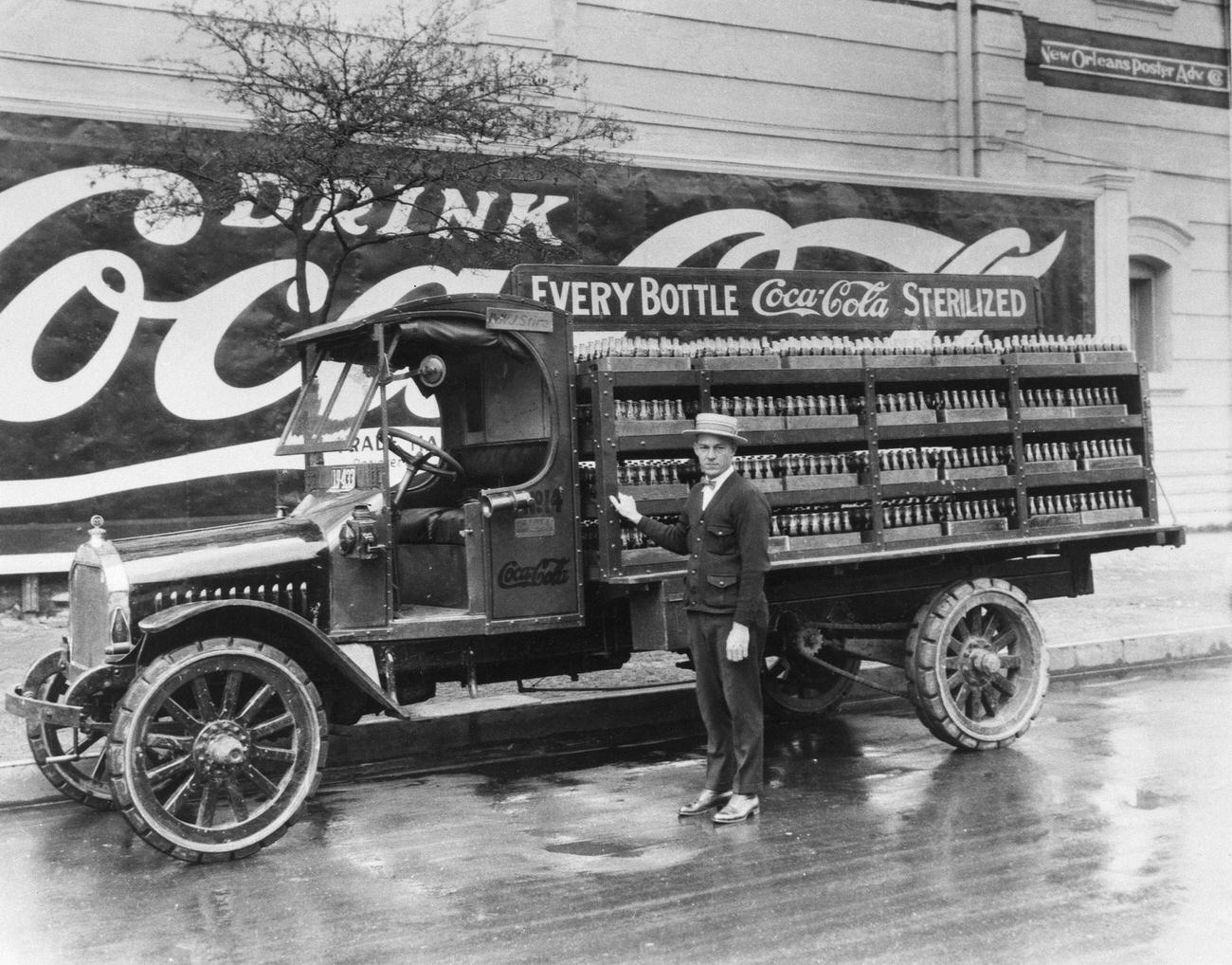 A driver in New Orleans with his Coca-Cola delivery truck full of bottled soft drinks, 1929.