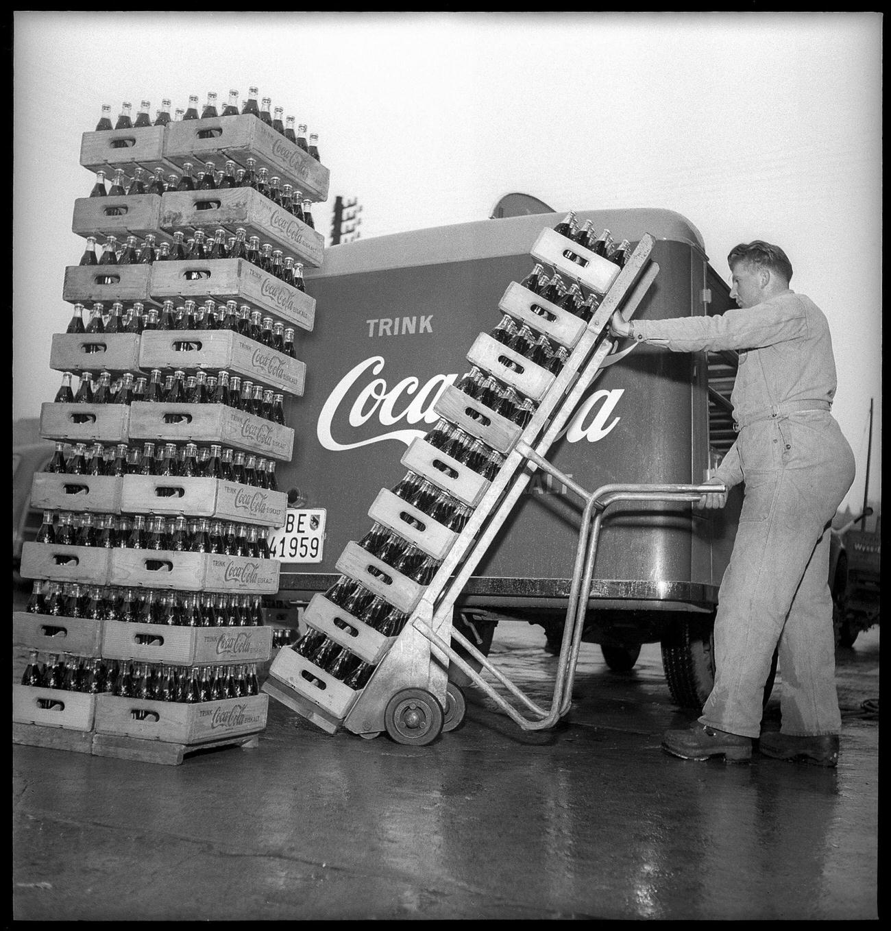 Coca-Cola worker loading a delivery van, 1949.