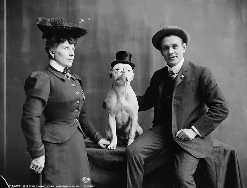 Victorian couple with dapper dog, 1900.