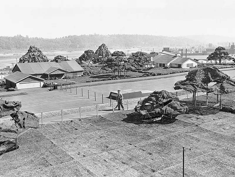 Camouflage trees and structures on Boeing Plant 2 roof, shorter than 6 feet.