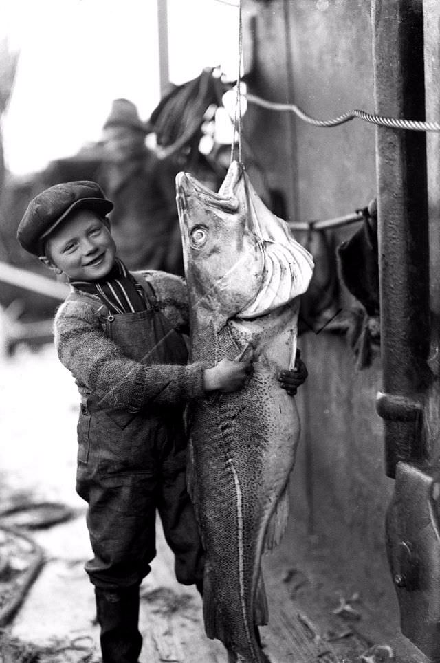 Boy with cod, Greenland, 1927.
