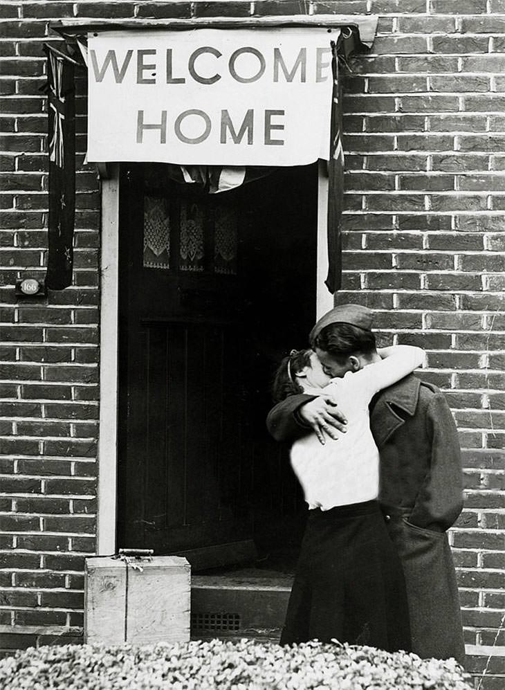British soldier kissing wife on return, 1945.