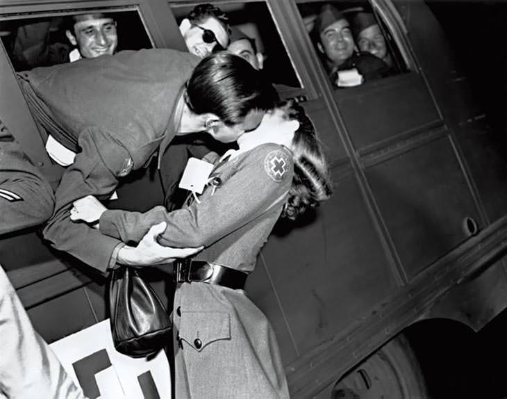 Soldier kissing Red Cross nurse, 1945.