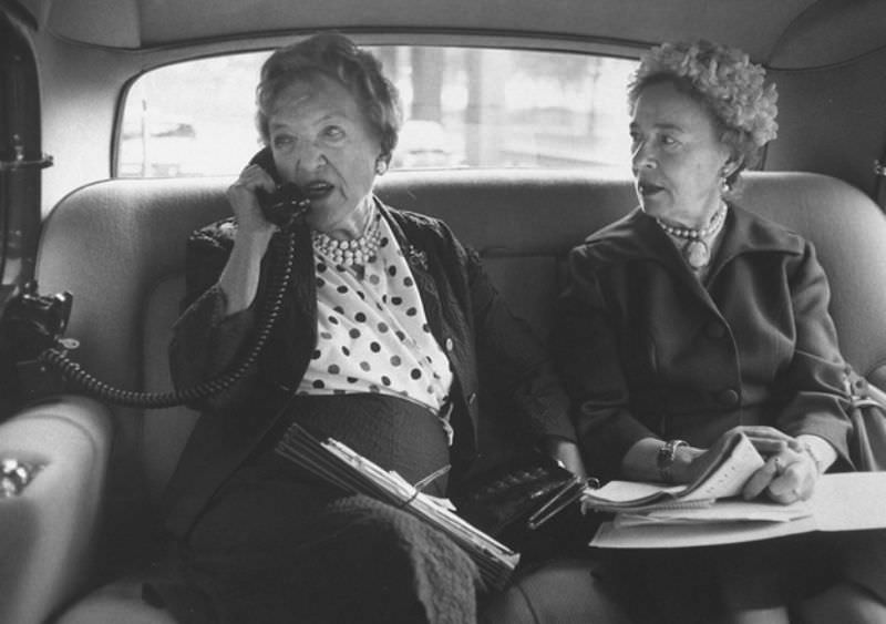 Old lady with car telephone, circa 1960.