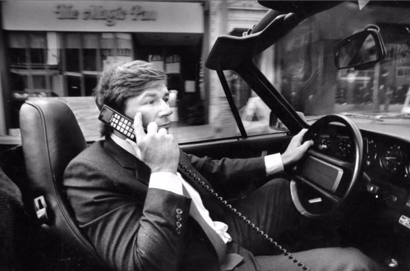 Michael Yancey on cell phone in Porsche, 1987.