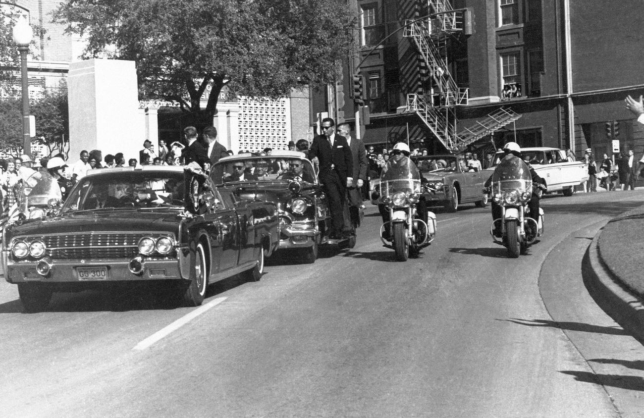 John F. Kennedy's motorcade near the Texas School Book Depository in Dallas, Texas, before his assassination, 1963.