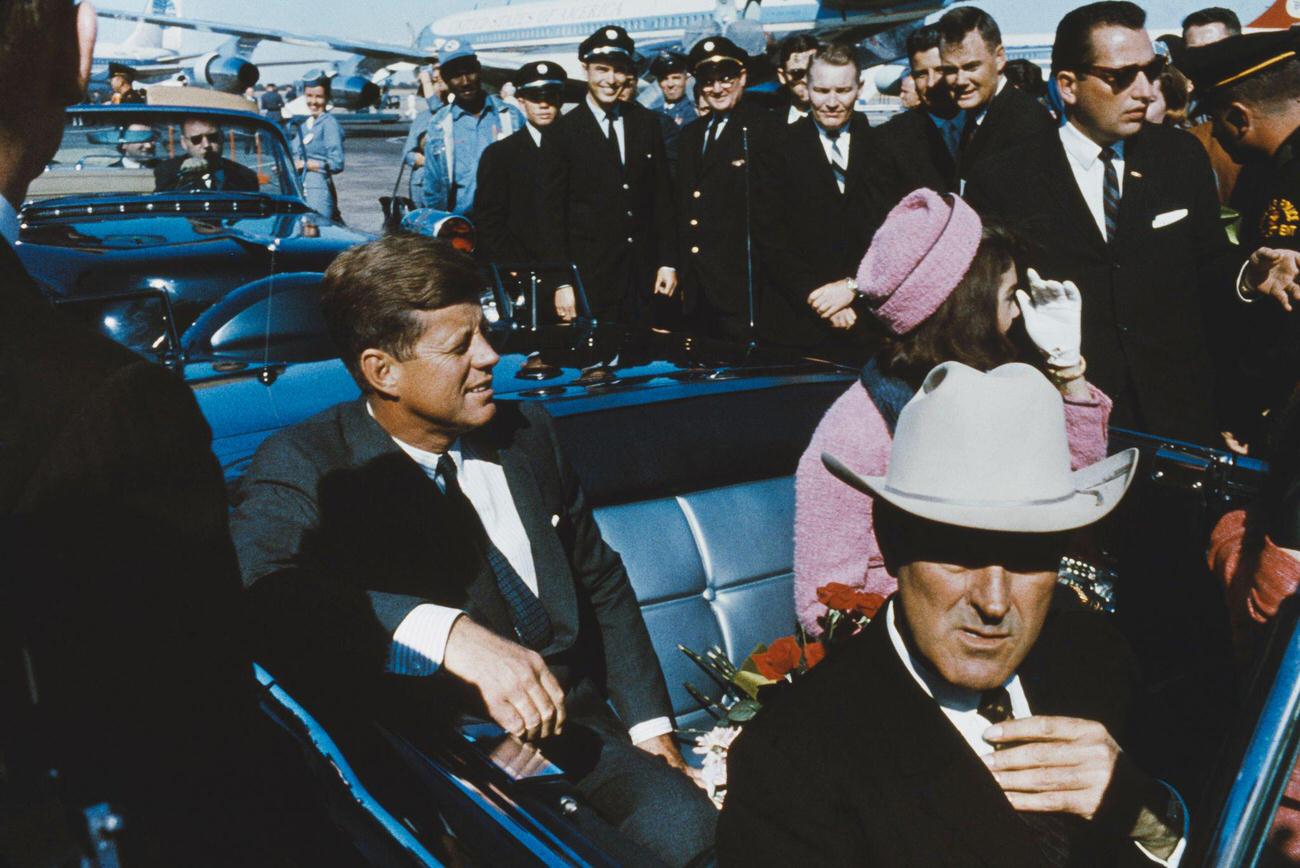 John F. Kennedy with Jacqueline Kennedy and Texas Governor John Connally in a limousine at Dallas Love Field airport, hours before the assassination, 1963.