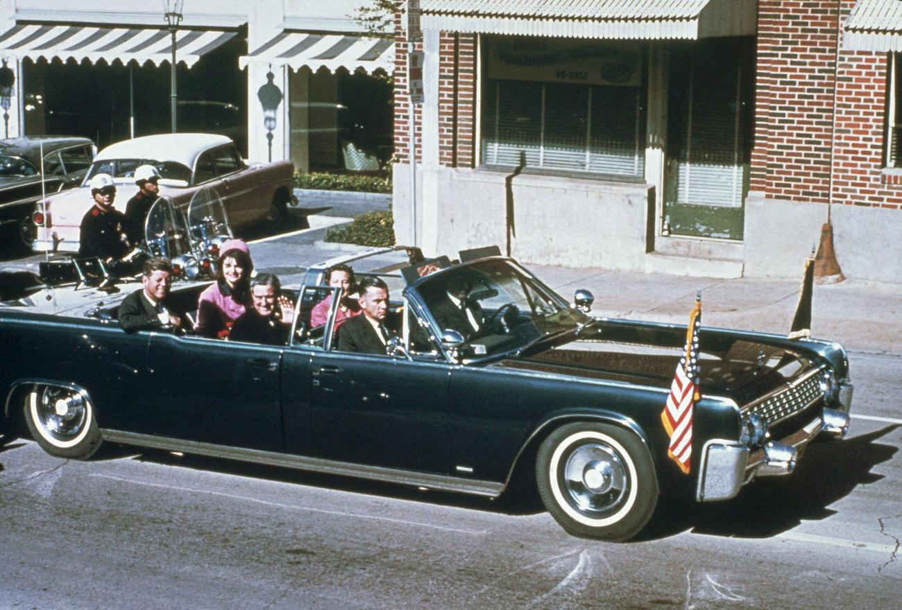 John F. Kennedy, First Lady Jacqueline Kennedy, Texas Governor John Connally, and his wife Nellie ride together in a Dallas limousine, 1963.