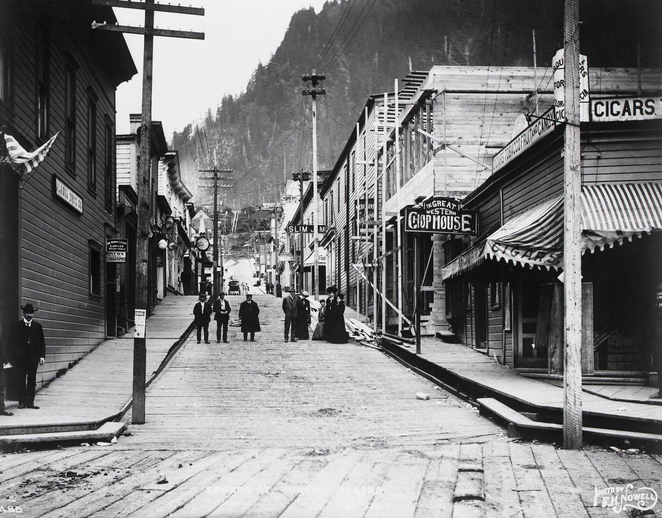 People gathered on Seward Street in a boom town during the Klondike Gold Rush, Alaska.