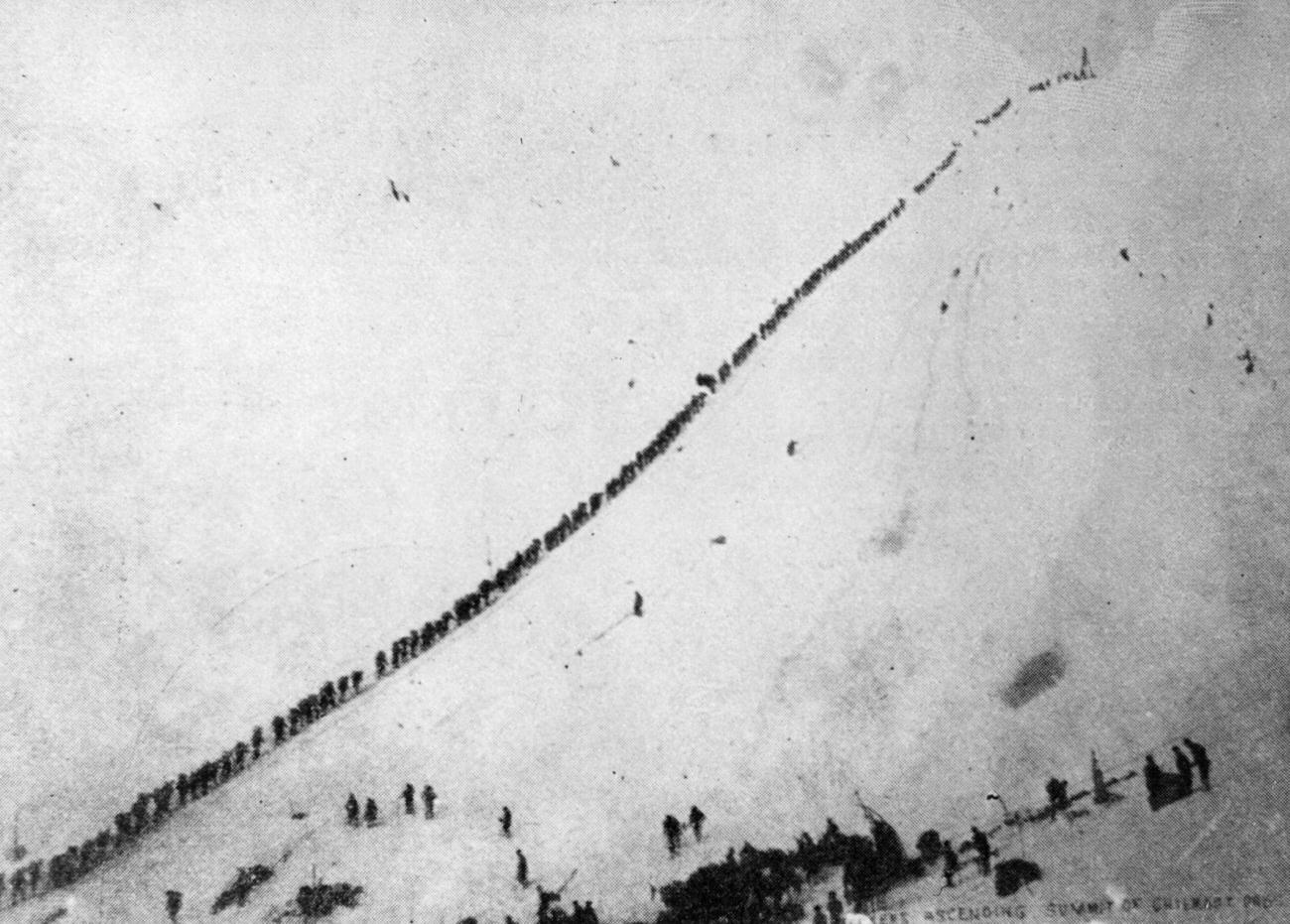 Prospectors ascending Chilcoot Pass by rope after gold discovery in the Klondike.