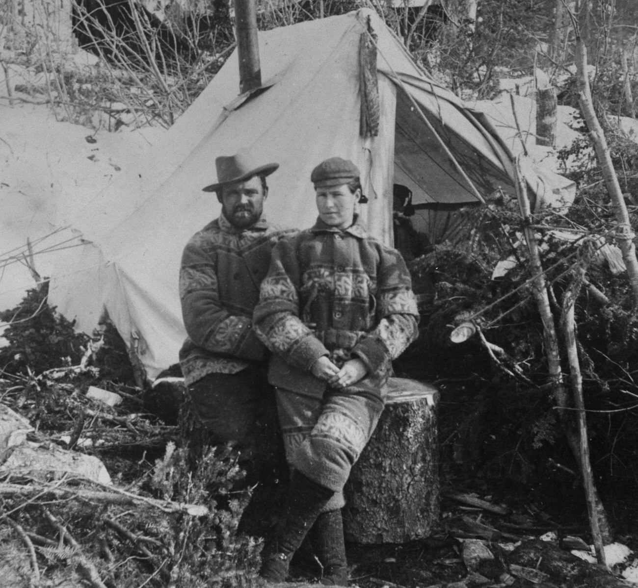 A man and woman in front of a tent in Alaska during the Klondike Gold Rush, 1898.