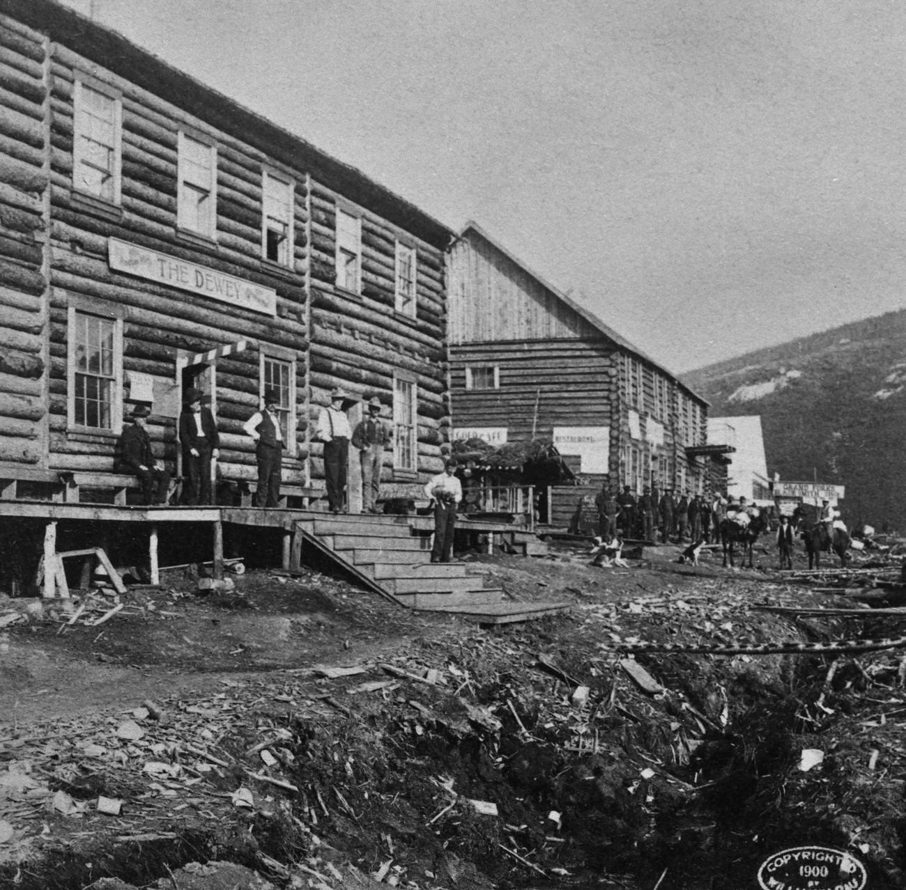 People outside hotels at the Grand Forks of the Eldorado and Bonanza Rivers during the Alaska Gold Rush, 1897.