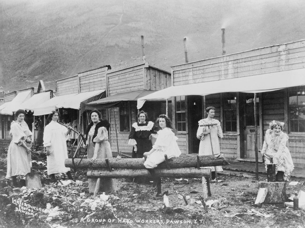 Women sawing logs in Dawson, Yukon Territory, during the Klondike Gold Rush.