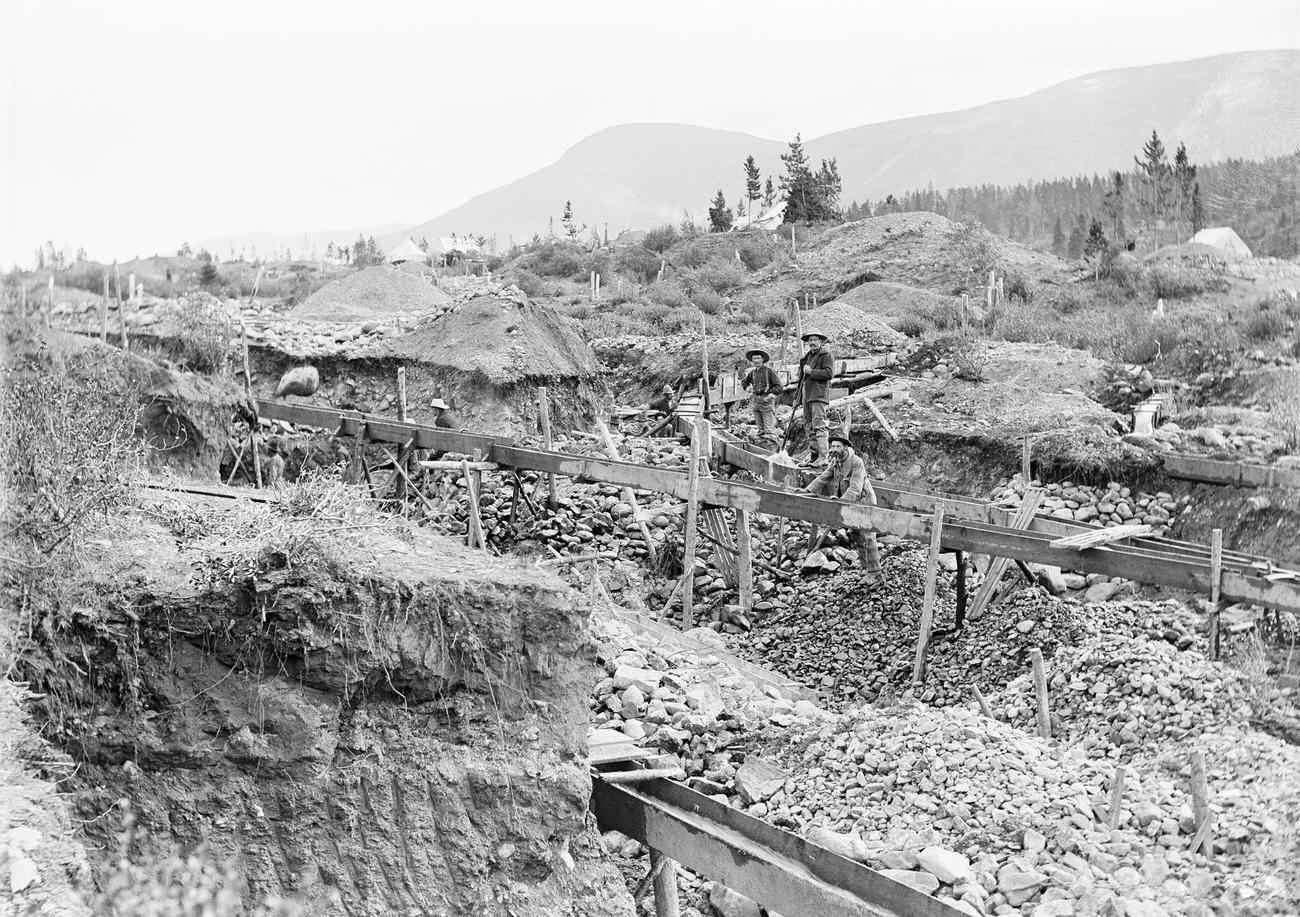 Willow Creek mining claim in Alaska, featuring sluice mining, circa 1900.
