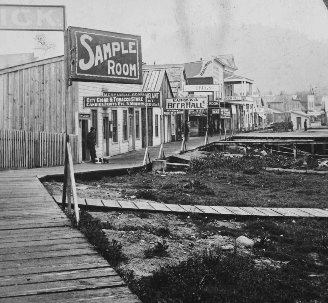 Main Street in Wrangell, Alaska, famous for saloons and totem poles, during the Klondike Gold Rush, circa 1900.