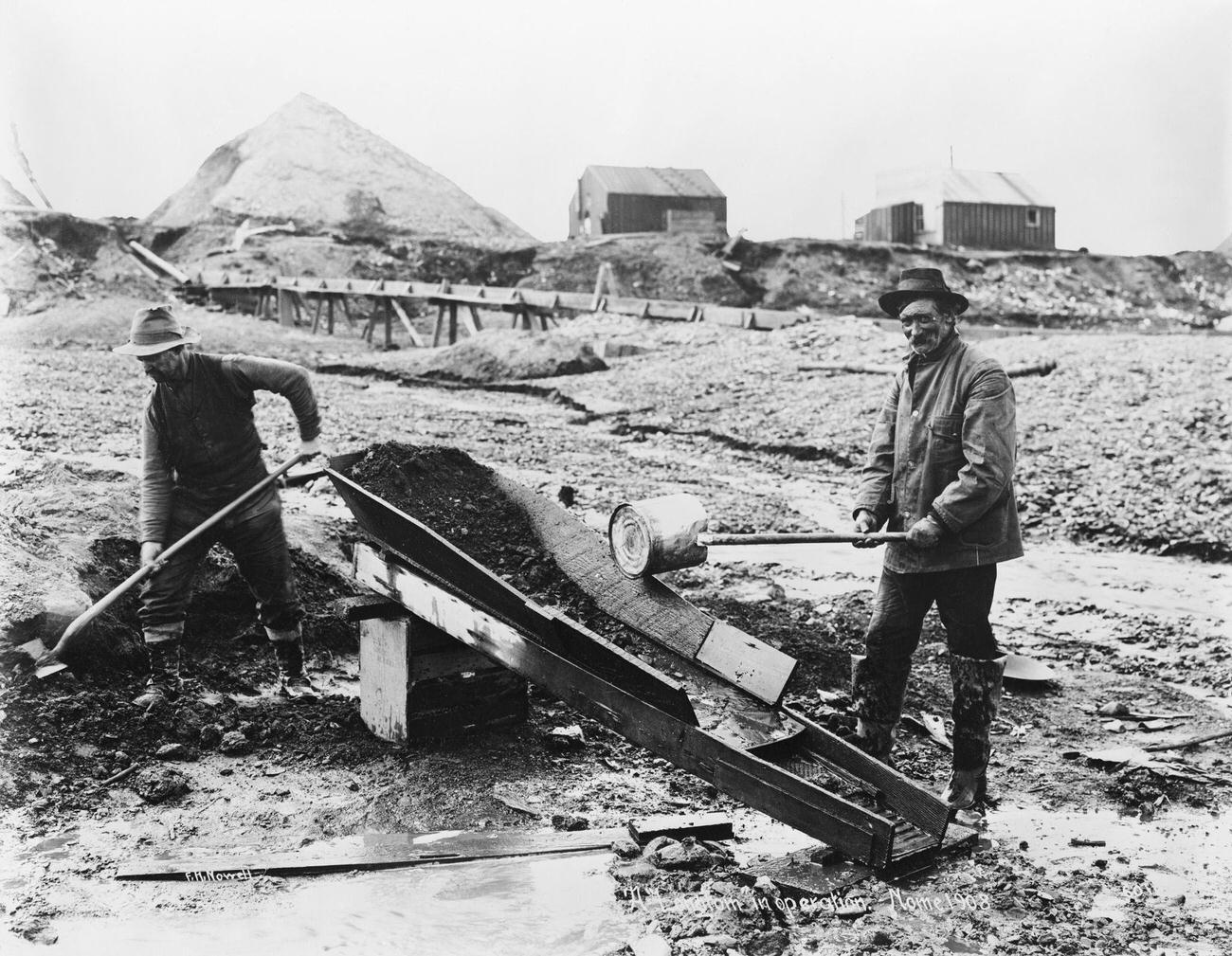 Long Tom in operation in Nome, Alaska, during the Klondike Gold Rush, 1908.