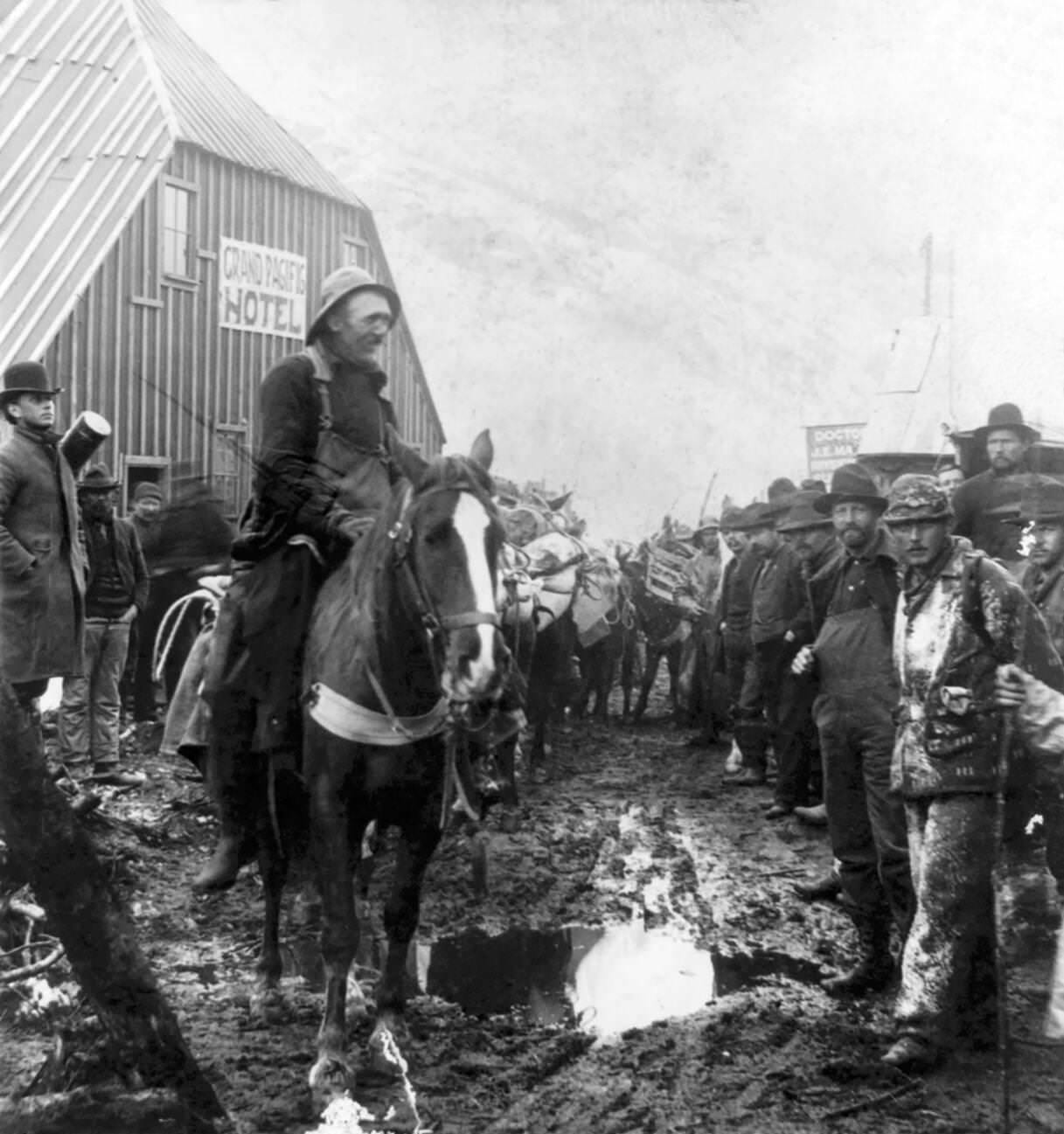 Gold prospectors in front of the Grand Pacific Hotel at Sheep Camp, Alaska, circa 1898.