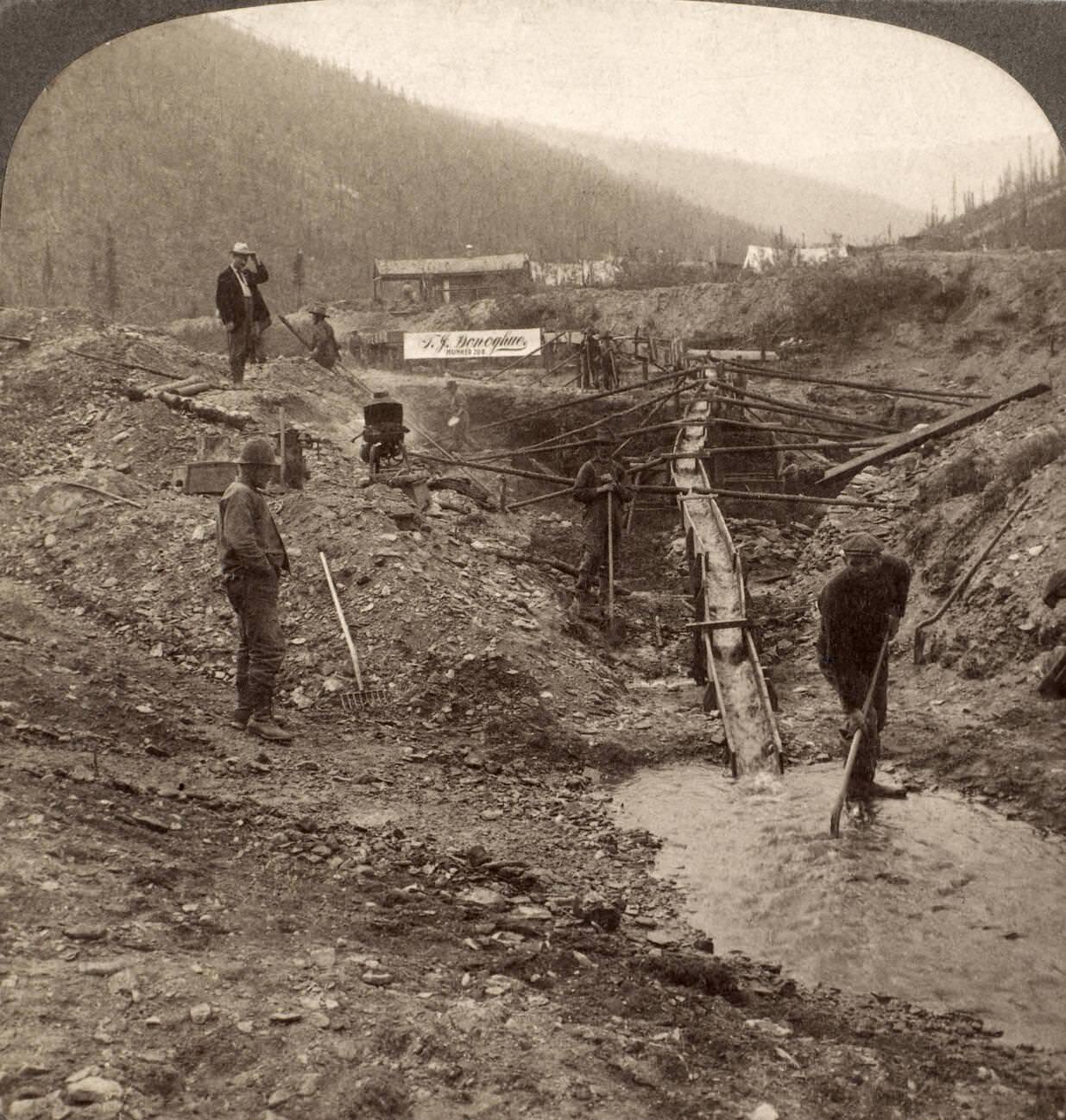 Miners working at a sluice box in Alaska during the Klondike Gold Rush, circa 1898.