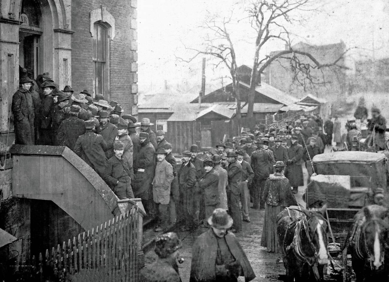 Long queue for mining licenses at Customs House, Victoria, British Columbia, Canada, 1898.