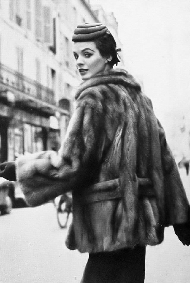 Linda Harper in a wild mink jacket with a low slotted belt by Christian Dior, Paris, 1953.