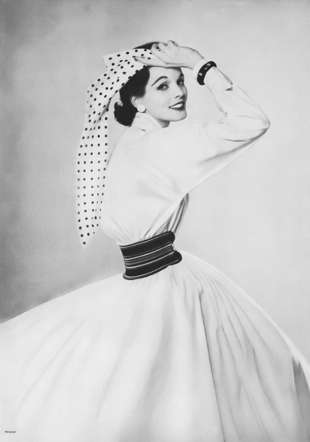 Linda Harper in a starch-white sheeting dress with a full-bloused yoke and bright waist garter by Craig, 1952.