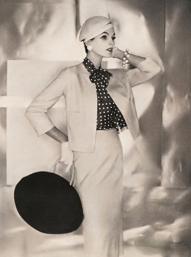 Linda Harper in a blond silk tussah jacket and skirt with a polka-dot blouse by Adele, 1956.