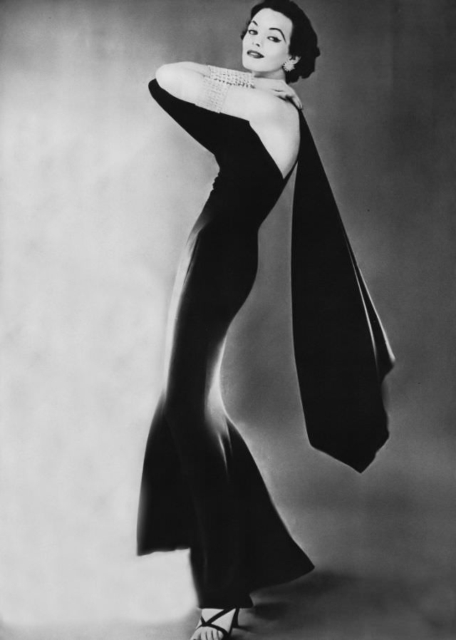 Linda Harper in a slinky black silk crêpe evening dress by Traina-Norell, 1952.