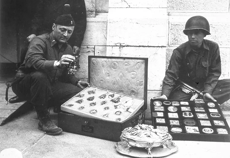 First Lieutenant James J. Rorimer, Sergeant Antonio T. Valin with recovered objects, Neuschwanstein, Germany, May 1945.