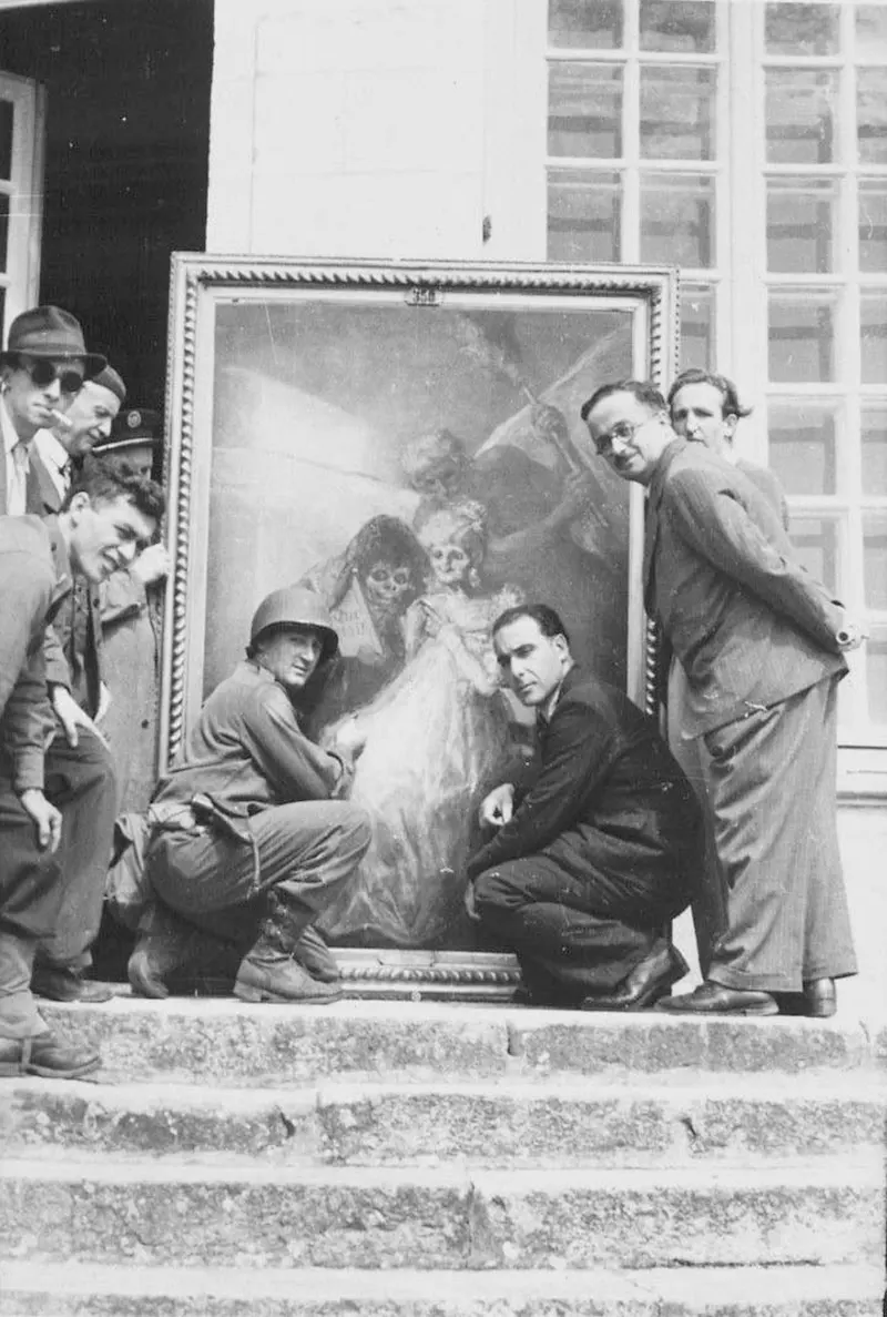 Monuments Man Daniel J. Kern, Karl Sieber with Jan van Eyck’s Adoration of the Mystic Lamb panels, Altaussee mine, 1945.
