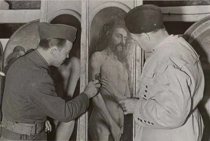 Lt. Daniel J. Kern, Karl Sieber examining Ghent Altarpiece panel, 1945.