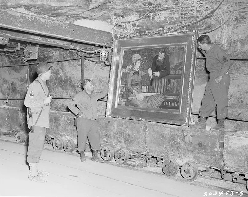 U.S. soldiers with Edouard Manet's “Wintergarden,” Nazi-looted art, Merkers mine.