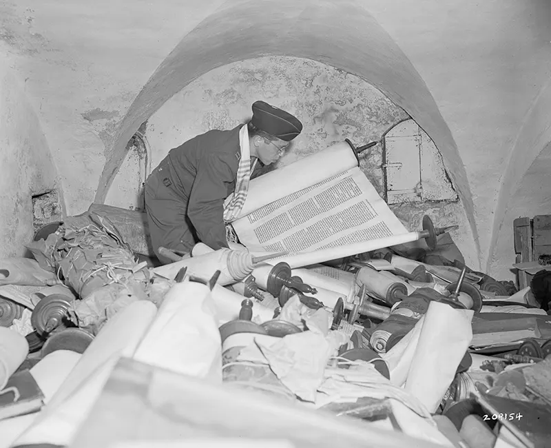 Chaplain Samuel Blinder inspecting recovered Saphor Torahs.