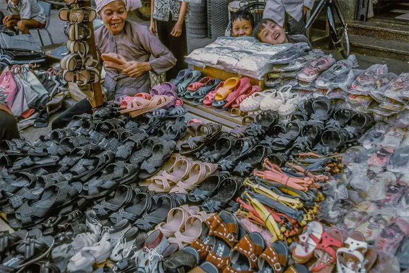 Shoe seller with children, My Tho market, 1969.