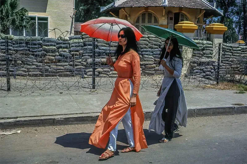 Women walking by military operational center, My Tho, 1969.