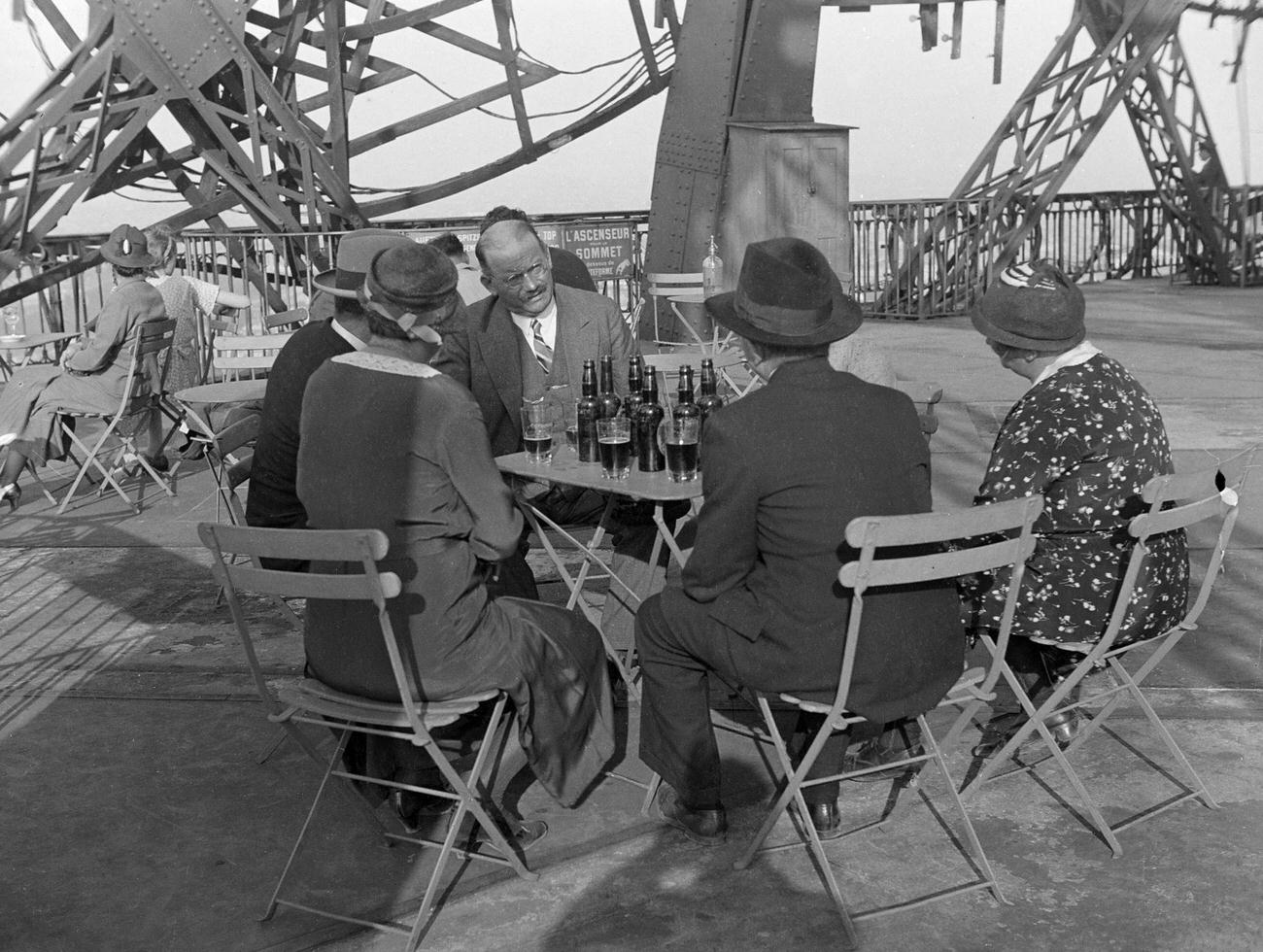 Tourists at a Cafe Terrace, Eiffel Tower, Paris, France, 1934