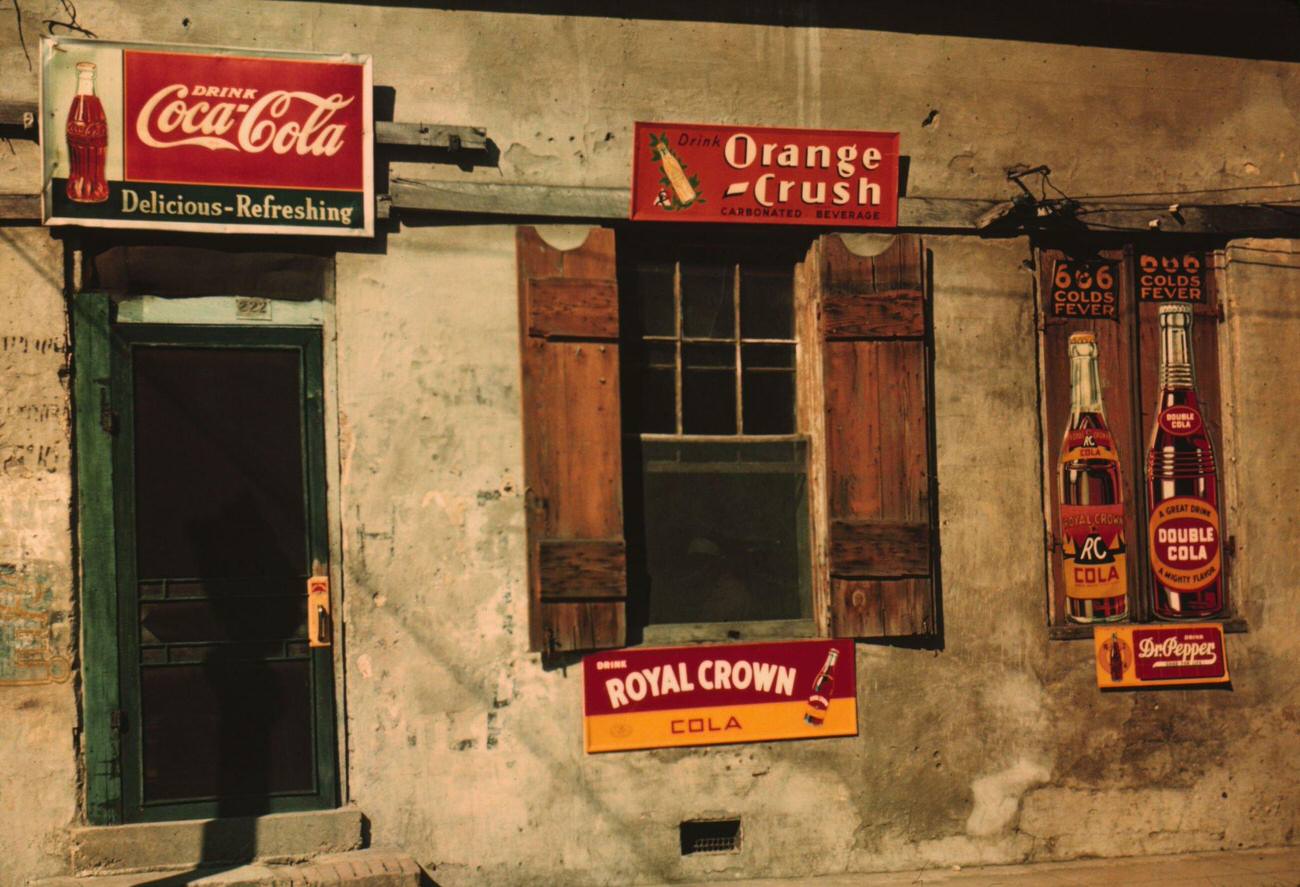Natchez, Mississippi, featuring signs for Coca-Cola, Orange Crush, and Royal Crown cola.