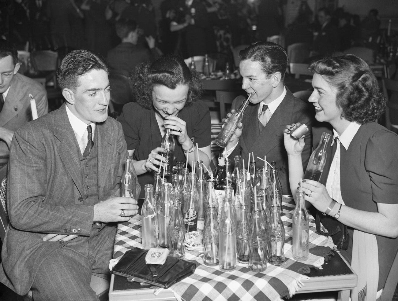 Convivial scene with Coca-Cola bottles at Pop and Ernie's club, April 6, 1938.