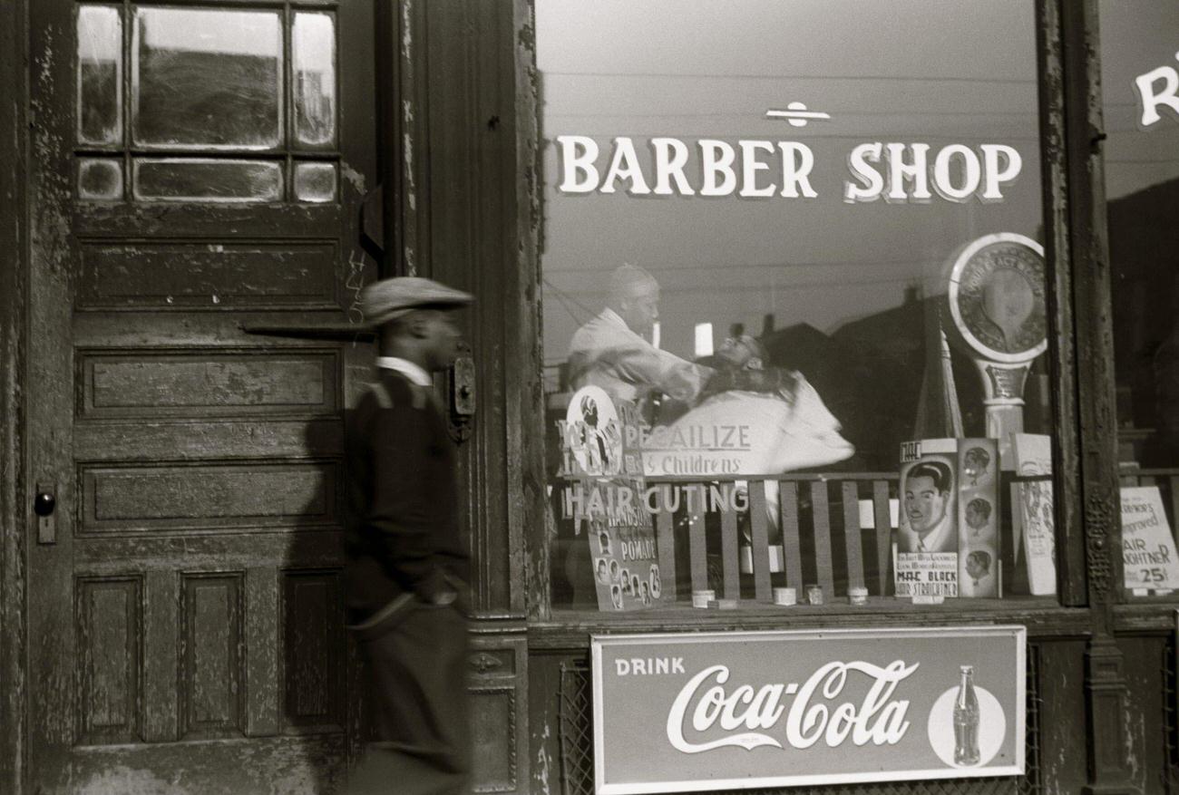 African American outside a barber shop in the Black Belt, Chicago, Illinois, circa 1941.