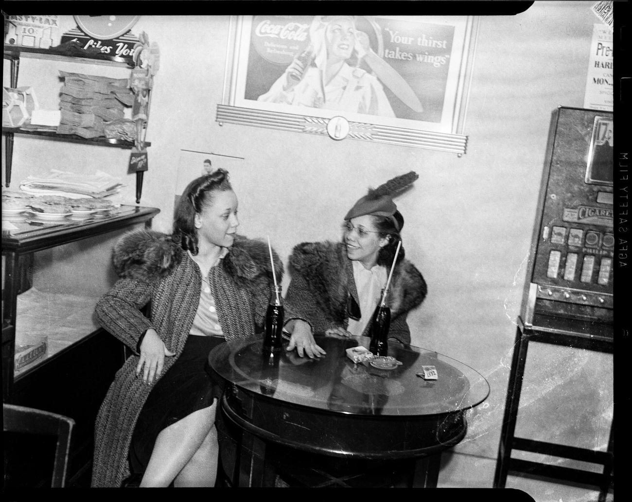 Ella Mae Lacey and Myrtle Thomas with Coca-Cola bottles in Lincoln Lunch Restaurant, Washington, Pennsylvania, March 1941.