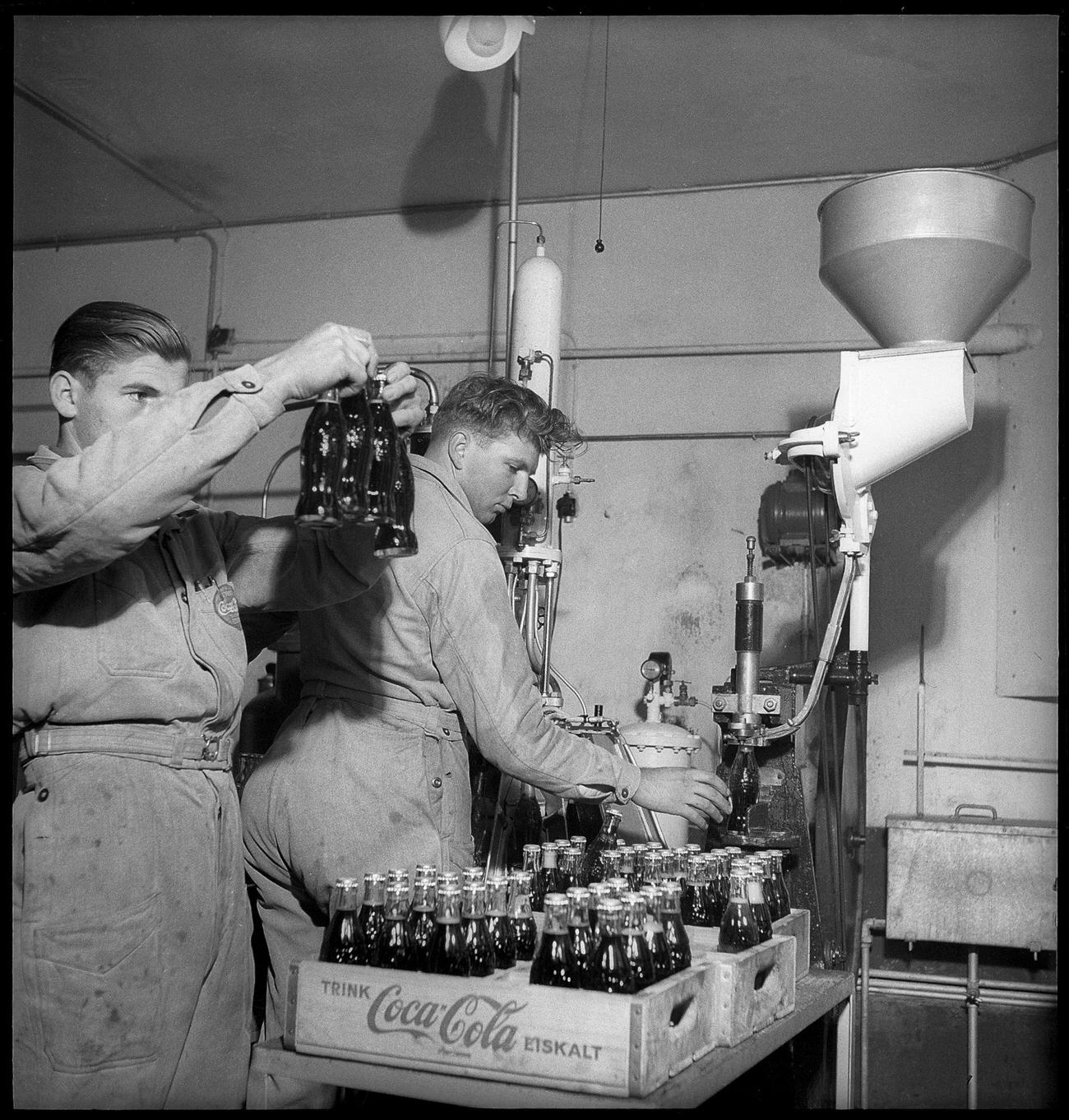 Coca-Cola worker at a bottling plant in Bern with a bottle, 1949.