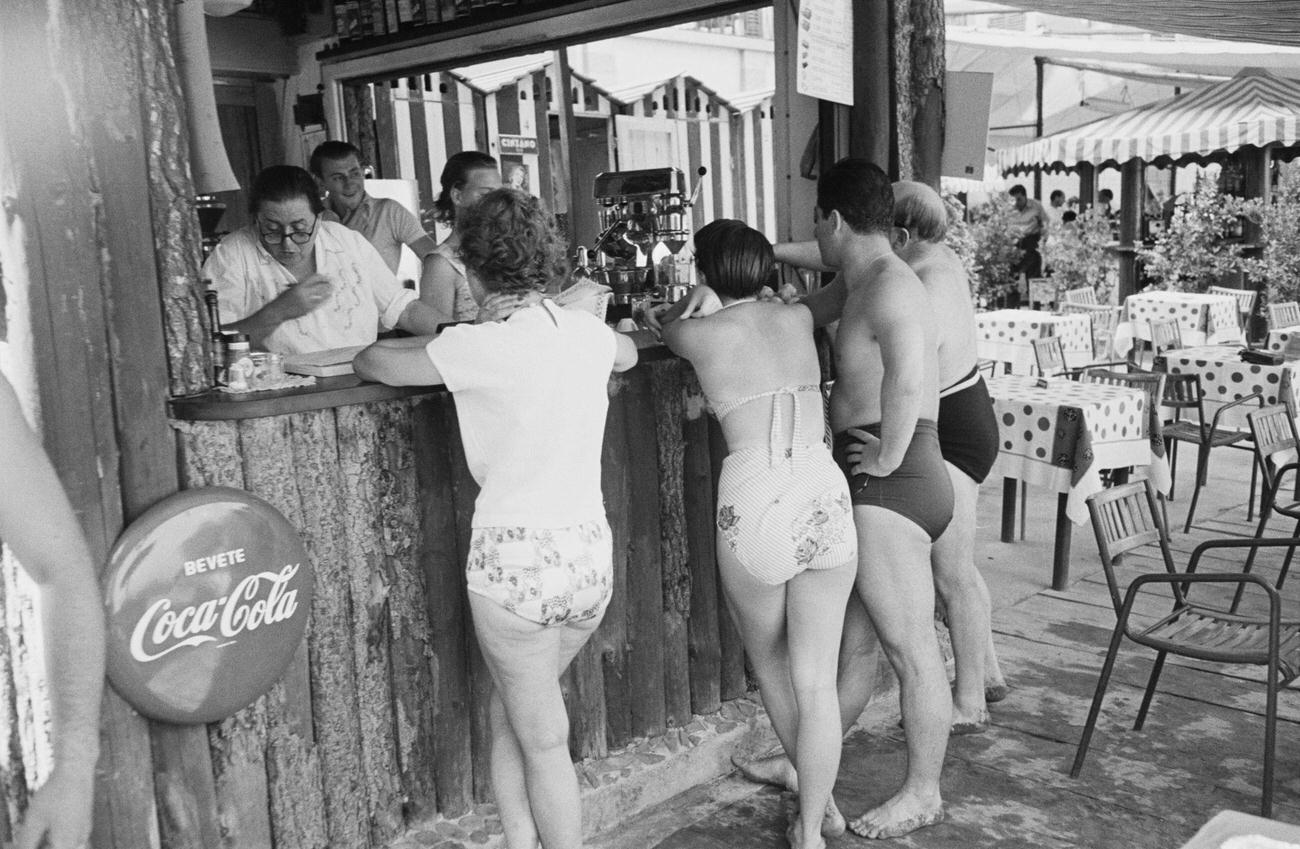 Customers at a bar on Paraggi Beach near Portofino, Italy, August 1952.