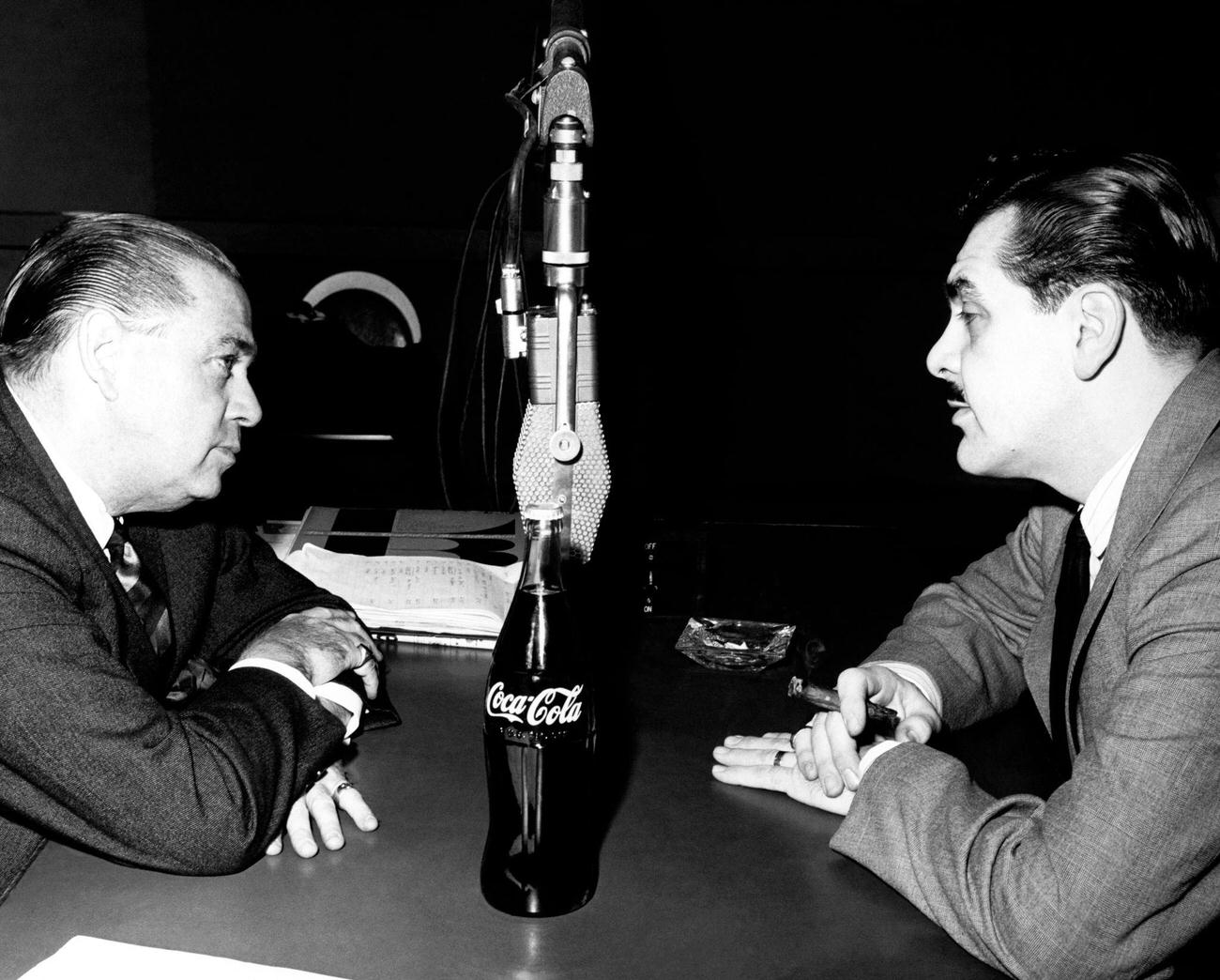 Comedian Ernie Kovacs talking to a disc jockey in New York, circa 1955.