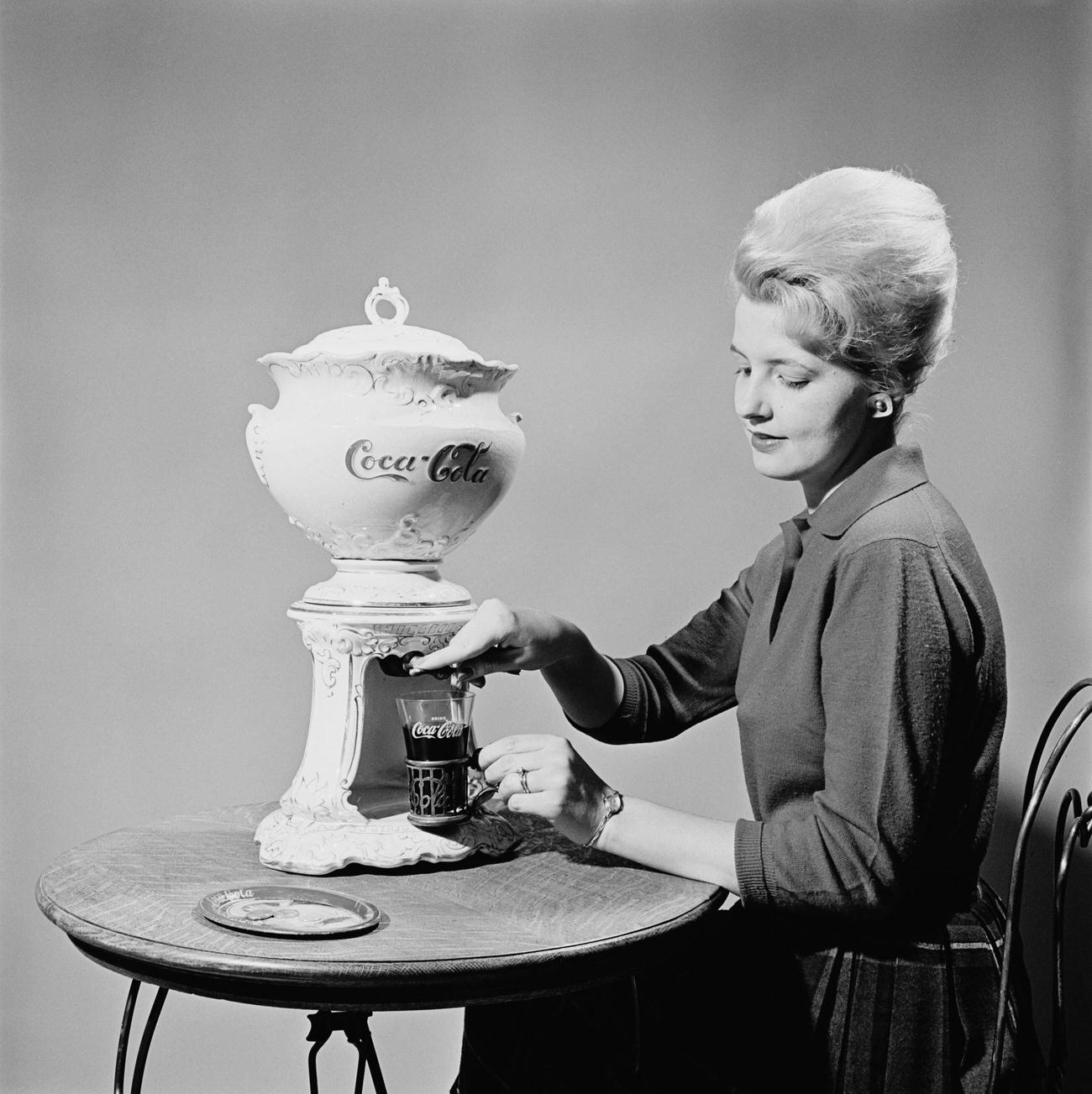 Woman pours Coca-Cola from a samovar at the Coca-Cola Museum in Atlanta, Georgia, circa 1960.