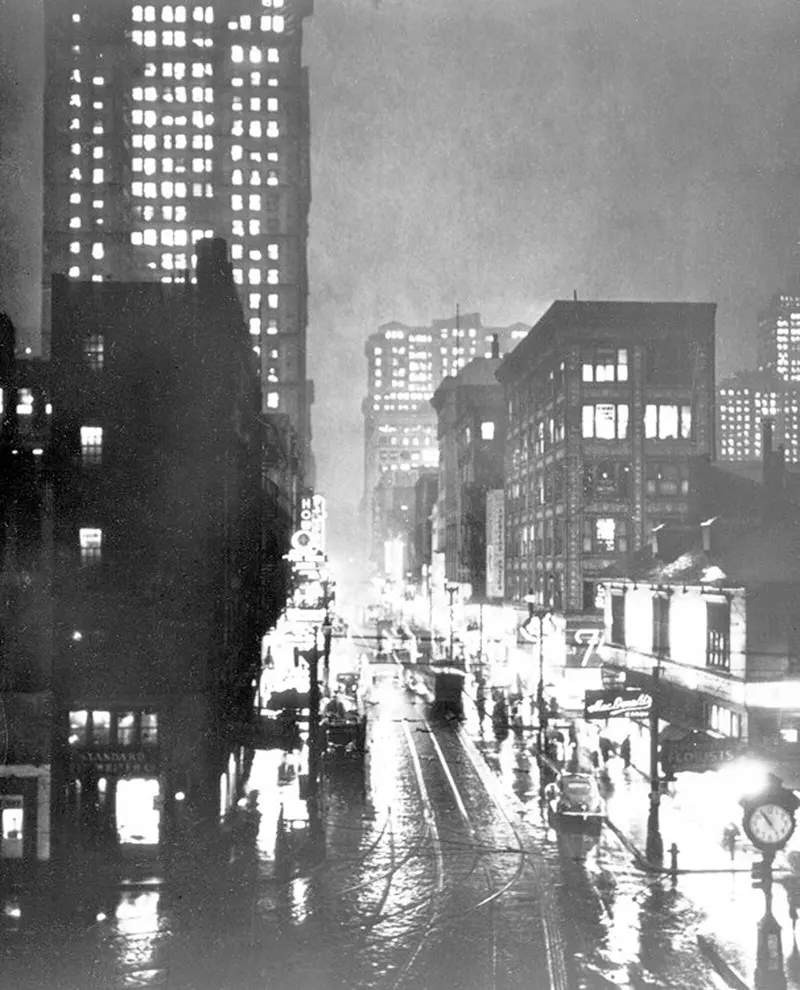 Elevated view of Liberty and Fifth Avenues with clock, busy street scene in smoke.