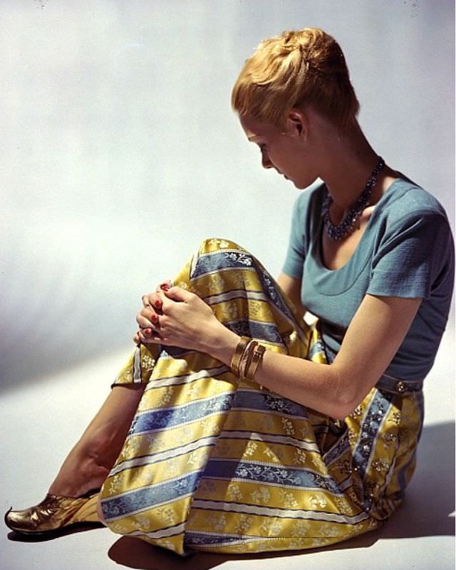 A model dons a light blue wool jersey and a printed rayon damask skirt with sequin details by Tina Leser, Vogue, 1944.