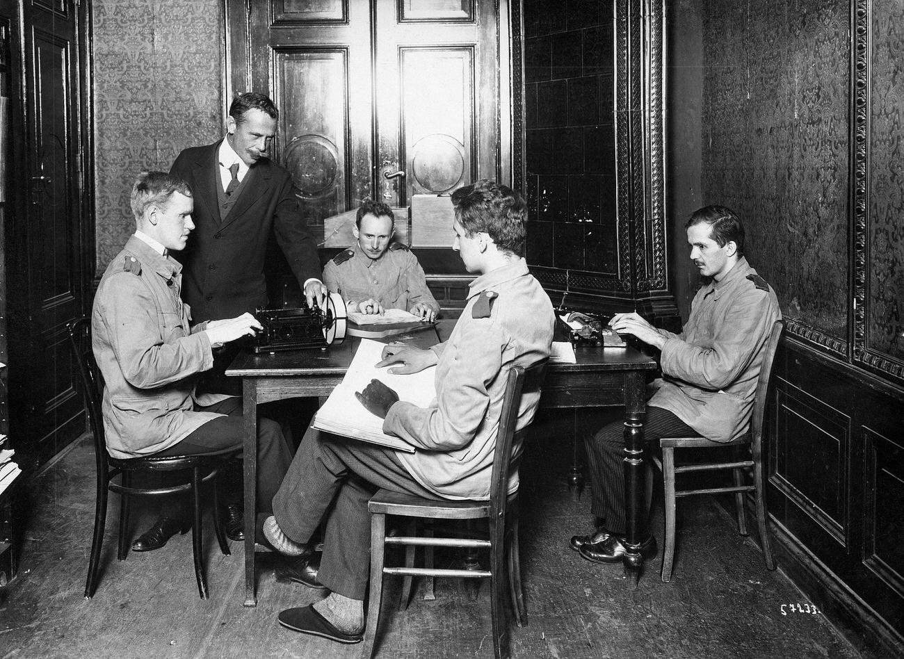 Blind teacher with blind pupils learning braille and typing, 1917.
