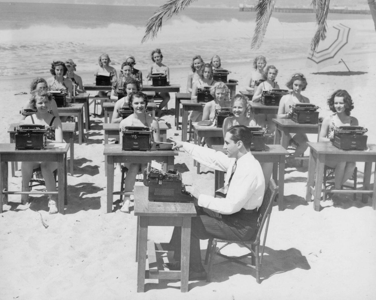 World champion typist Albert Tangira teaching typing class on a beach, 1920s or 1930s.